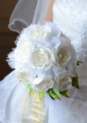 花嫁が手に持つ白いバラのブーケ